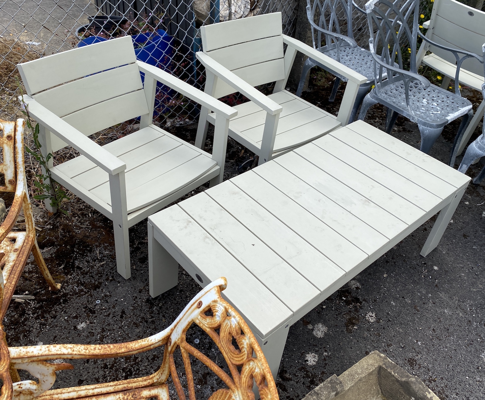 A Laura Ashley painted teak rectangular garden coffee table, length 124cm, depth 60cm, height 42cm and two elbow chairs